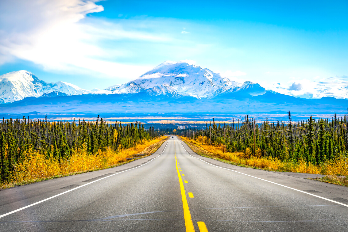 Alaska road trip with mountain and blue sky